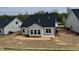 Home exterior and backyard awaiting landscaping shows the patio and view of the house at 1056 Fairhaven Dr # 97, Mebane, NC 27302