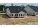 New home construction backyard awaiting landscaping with view of house siding and windows at 1056 Fairhaven Dr # 97, Mebane, NC 27302