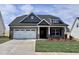 Beautiful single-story brick home featuring a two-car garage and inviting front porch at 1056 Fairhaven Dr # 97, Mebane, NC 27302