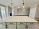 Open concept kitchen boasts a large island with pendant lighting and views into the living areas at 1056 Fairhaven Dr # 97, Mebane, NC 27302