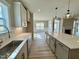 Bright, open kitchen features quartz counters, stainless steel appliances, and hardwood flooring at 1056 Fairhaven Dr # 97, Mebane, NC 27302