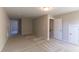 Spacious living room area with neutral carpeting and hallways to other rooms at 1056 Fairhaven Dr # 97, Mebane, NC 27302