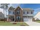 Beautiful two-story home featuring brick and gray siding, a two-car garage, and manicured front lawn at 1237 Jasmine View Way, Knightdale, NC 27545