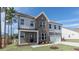 Attractive two-story home boasts a brick facade, covered porch, tidy landscaping, and a two-car garage at 1237 Jasmine View Way, Knightdale, NC 27545