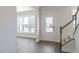 Inviting foyer with dark wood floors, a bright window, and a staircase leading to the second floor at 1237 Jasmine View Way, Knightdale, NC 27545
