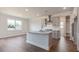 Bright kitchen with stainless steel appliances, a center island, and a view into the dining area at 1237 Jasmine View Way, Knightdale, NC 27545