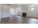 Spacious living room featuring hardwood floors, a fireplace, and abundant natural light at 1237 Jasmine View Way, Knightdale, NC 27545