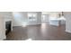 Spacious living area showcasing hardwood floors, fireplace, and an open layout into the kitchen at 1237 Jasmine View Way, Knightdale, NC 27545