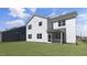 Expansive backyard shows the rear of a two-story home with white siding and a screened-in porch at 512 Lemon Daisy Ln, Knightdale, NC 27545