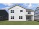 Spacious backyard shows the rear of a two-story home with white siding and a screened-in porch at 512 Lemon Daisy Ln, Knightdale, NC 27545