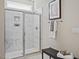 Bathroom featuring walk-in shower with marble tile, glass door, bench, and sleek fixtures at 512 Lemon Daisy Ln, Knightdale, NC 27545