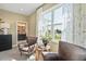 Cozy bedroom seating area with view of backyard, designer curtains, and neutral walls at 512 Lemon Daisy Ln, Knightdale, NC 27545