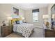 Nicely decorated bedroom with side tables, lamps, a 'Game Over' pillow, and a window for natural light at 512 Lemon Daisy Ln, Knightdale, NC 27545