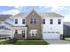 New two story construction featuring brick and light siding with an attached two car garage at 512 Lemon Daisy Ln, Knightdale, NC 27545
