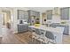 Charming kitchen featuring gray cabinets, quartz countertops, stainless steel appliances, and bar stool seating at 512 Lemon Daisy Ln, Knightdale, NC 27545