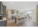 Open kitchen boasts gray cabinets, stainless steel appliances, and a large island with seating, flowing into the dining area at 512 Lemon Daisy Ln, Knightdale, NC 27545