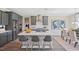 Contemporary kitchen featuring gray cabinets, a large island, stainless steel appliances, and an adjacent dining area at 512 Lemon Daisy Ln, Knightdale, NC 27545