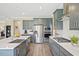 Well-lit kitchen features stainless steel appliances, quartz countertops, gray cabinetry, and a gas range at 512 Lemon Daisy Ln, Knightdale, NC 27545