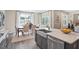 Modern kitchen island featuring a stainless steel sink, quartz countertop, and a view of the dining area at 512 Lemon Daisy Ln, Knightdale, NC 27545