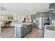 Open-concept kitchen island overlooks a spacious living room with fireplace, providing a seamless entertaining space at 512 Lemon Daisy Ln, Knightdale, NC 27545