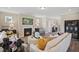 Cozy living room features a fireplace, stylish furnishings, and an open layout to the foyer at 512 Lemon Daisy Ln, Knightdale, NC 27545