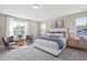 Bright main bedroom features large windows, stylish decor, and comfortable furnishings at 512 Lemon Daisy Ln, Knightdale, NC 27545