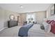 Spacious main bedroom with a large bed, dresser, and stylish furnishings at 512 Lemon Daisy Ln, Knightdale, NC 27545