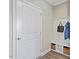 Welcoming mudroom with built-in bench, coat hooks, storage baskets, and access to the rest of the house at 512 Lemon Daisy Ln, Knightdale, NC 27545