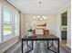 Bright home office featuring a large window, modern light fixture, and stylish décor at 512 Lemon Daisy Ln, Knightdale, NC 27545