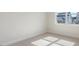 A simple bedroom with neutral carpet and a window with an outside view at 524 Lemon Daisy Ln, Knightdale, NC 27545
