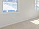 Unfinished bedroom with carpeted floors and bright natural light from two windows at 524 Lemon Daisy Ln, Knightdale, NC 27545