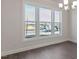 Well-lit dining room showcasing hardwood floors, large windows, and a modern chandelier at 524 Lemon Daisy Ln, Knightdale, NC 27545