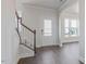 Bright foyer featuring hardwood floors, staircase, and front door with sidelight windows at 524 Lemon Daisy Ln, Knightdale, NC 27545
