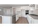 Stylish kitchen showcasing white cabinets, stainless steel appliances, and wood flooring at 524 Lemon Daisy Ln, Knightdale, NC 27545