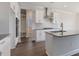 Modern kitchen with white cabinets, gray countertops, stainless steel appliances and island at 524 Lemon Daisy Ln, Knightdale, NC 27545