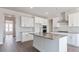 Modern kitchen featuring white cabinets, stainless steel appliances, and a large island with stone countertop at 524 Lemon Daisy Ln, Knightdale, NC 27545