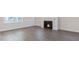 Cozy living room featuring a fireplace, hardwood floors, and natural light at 524 Lemon Daisy Ln, Knightdale, NC 27545