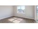 Bright, empty room with a large window providing plenty of natural light at 524 Lemon Daisy Ln, Knightdale, NC 27545