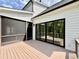 Spacious deck area with access to the home's interior via sliding glass doors and screened-in porch at 205 Red Cardinal Ct, Youngsville, NC 27596