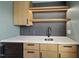 Modern bar with marble counters, wood cabinets, wine fridge and stainless steel sink at 205 Red Cardinal Ct, Youngsville, NC 27596