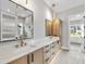 Bathroom features double vanity, marble countertops, modern fixtures, and glass enclosed shower with tiled surround at 205 Red Cardinal Ct, Youngsville, NC 27596