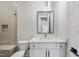 Bathroom featuring white vanity with marble countertop, modern lighting fixture, and tiled shower with glass door at 205 Red Cardinal Ct, Youngsville, NC 27596