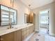 Modern bathroom features double sink vanity with marble countertop, and a walk-in shower with glass door at 205 Red Cardinal Ct, Youngsville, NC 27596