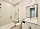 Modern bathroom with tile shower, glass door, and white vanity with black hardware at 205 Red Cardinal Ct, Youngsville, NC 27596
