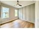 Clean bedroom features hardwood floors, modern ceiling fan, and painted accent wall at 205 Red Cardinal Ct, Youngsville, NC 27596