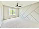 Inviting bedroom featuring a ceiling fan and a custom geometric accent wall at 205 Red Cardinal Ct, Youngsville, NC 27596