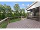 Wood deck with screened porch view in the background overlooking a well-maintained lawn at 205 Red Cardinal Ct, Youngsville, NC 27596