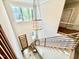 Elegant entryway showcasing a contemporary chandelier, staircase, and wood-paneled front door at 205 Red Cardinal Ct, Youngsville, NC 27596