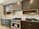 Kitchen featuring stainless steel appliances, dark cabinets, and marble countertops and backsplash at 205 Red Cardinal Ct, Youngsville, NC 27596