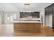 A gourmet kitchen with a large island, modern cabinetry, designer lighting, and stainless steel appliances at 205 Red Cardinal Ct, Youngsville, NC 27596
